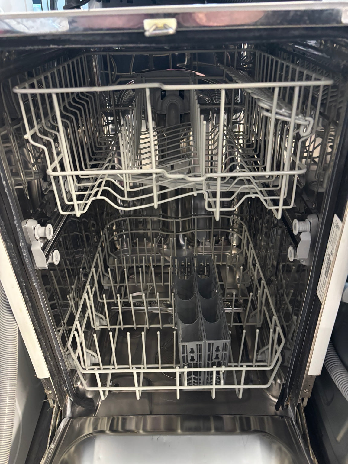Actual stainless steel interior of used 18-inch Frigidaire dishwasher