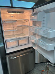 GE refrigerator interior with shelves, drawers and door bins