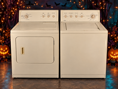 Matching bisque Kenmore washer and dryer set on Halloween background
