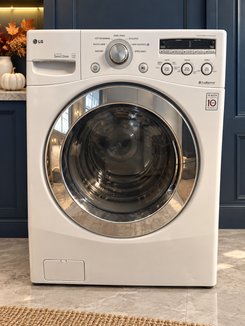 Used white LG 27-inch front-load washer on navy autumn background